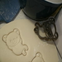 Medvjedić opušteno leži u rezaču kolačića Proizvedeno u SAD-u 9778